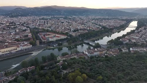 Florence Arno River and historic cityscape at sunrise drone establishing shot