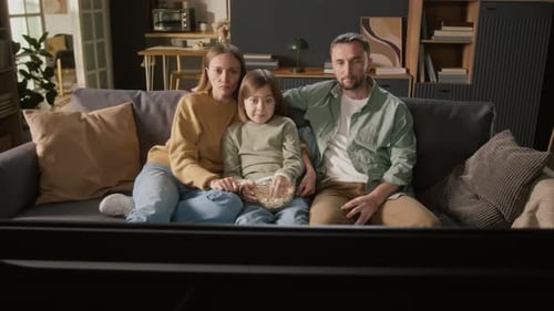 Family Watches a Scary Movie Together on Couch