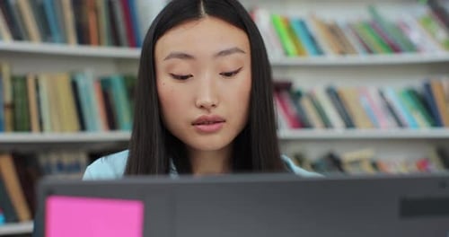 Close Up Portrait Beautiful Asian Girl in Reading Book and Typing on Computer