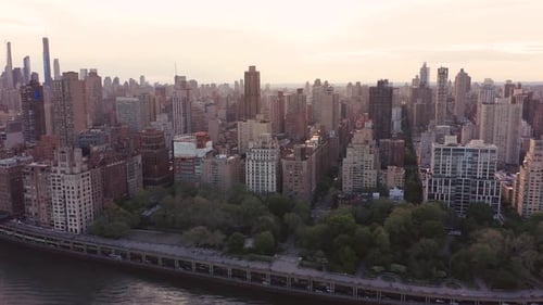 Aerial footage up the edge of Manhattan, NYC. Epic moving view of concrete canyons and legendary sky