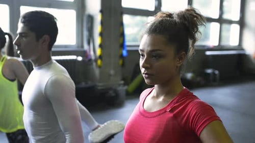 People Exercise Together in Gym, Doing Lunges