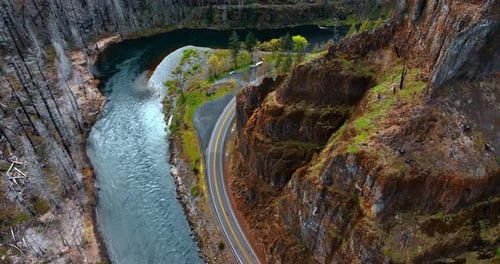 Rising over the narrow river floating through the mountainous area.