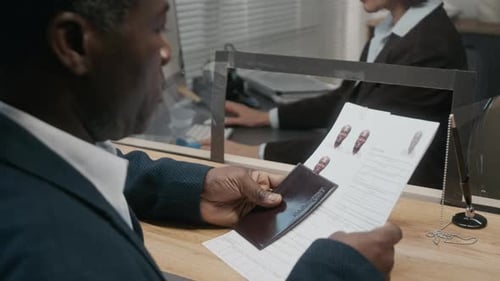 Man Submits Application to Woman Behind Protective Window