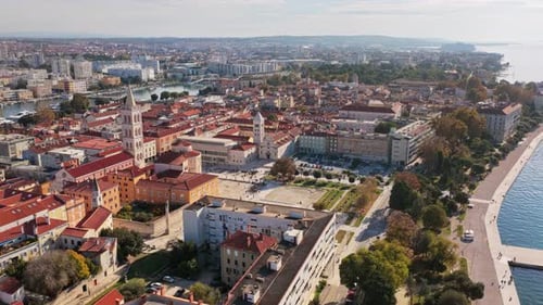 Aerial drone view of Zadar's waterfront and historic Old Town, with St. Anastasia Cathedral's bell t