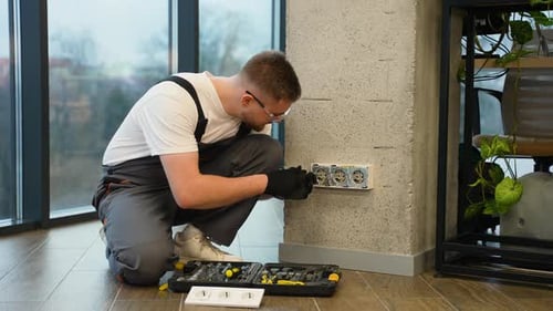 Professional Electrician Installing Wall Socket Power Outlet