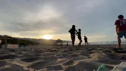 time interval people play ball on the beach