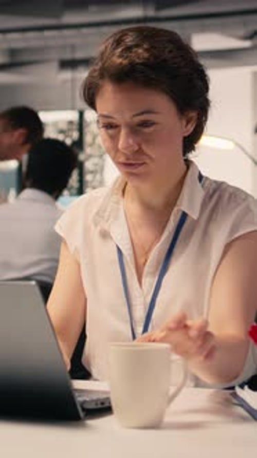 Vertical Video Professional Businesswoman Focused on Forecasting Reports and KPI Analysis