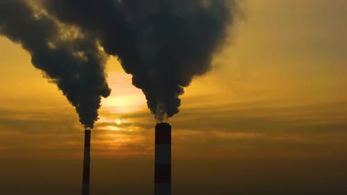 Air pollution. clouds of smoke coming from the chimneys of the plant with beautiful golden yellow li