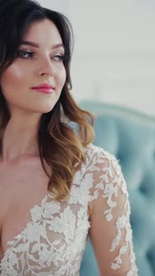 Elegant Woman in Wedding Dress Holds Bouquet