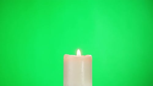 Burning Wax Candle on Green Chroma Key Background