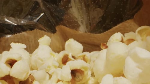 Making Popcorn on Black Pan Closeup Macro Corn Kernels are Popping and Cooking Snack Food