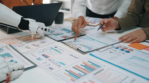 Business Team Analyzing Graphs with Robot Arm