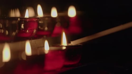 Candles Being Lit in the Darkness