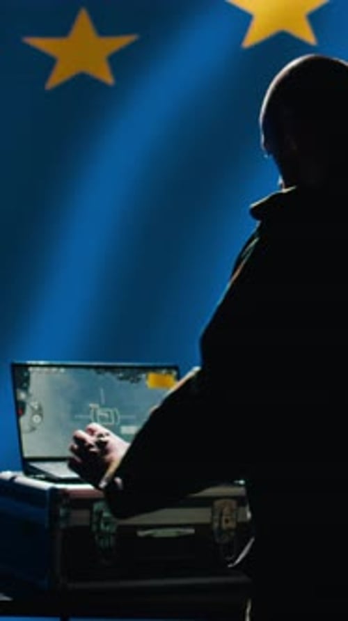 Man in Silhouette with Laptop and EU Flag