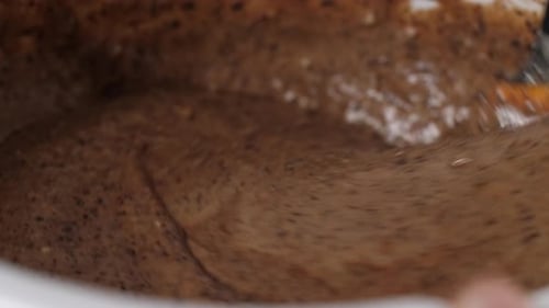 Brown Batter is Stirred in a White Bowl