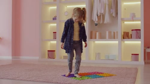 Child Walking Barefoot on Colorful Foot Massage Mat