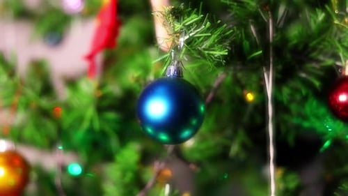 Blue Christmas Ornament Hanging on Green Tree