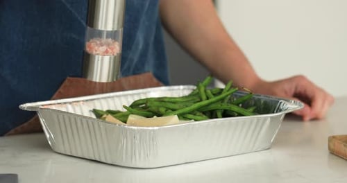 The Chef Salts Vegetables with an Electric Salt Shaker Manual Grinder for Salt