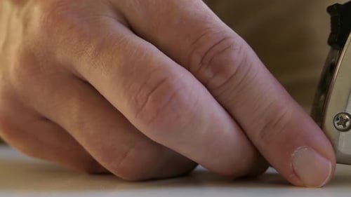 Man opening tape measure and measuring, centimeters, close up