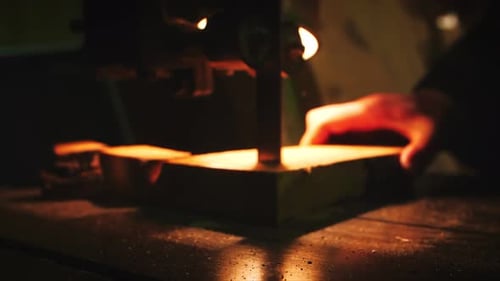 Carpenter cutting wooden board with table saw in workshop, close up