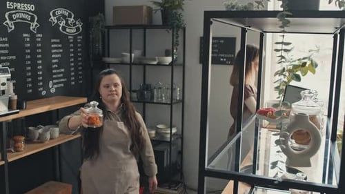 Young Woman With Disability Working In Cafe