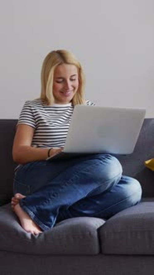 Woman With Laptop On Couch Using Computer