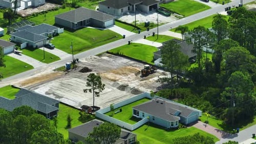 Earth Moving Tractor Preparing Place for Future House Foundation Construction