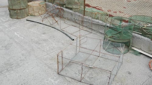 Empty fishing nets laying around at old harbour, fishing equipment