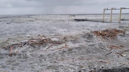 Large Foamy Waves are Hitting Shore City Beach and Embankment Affected By Hurricane Day Before