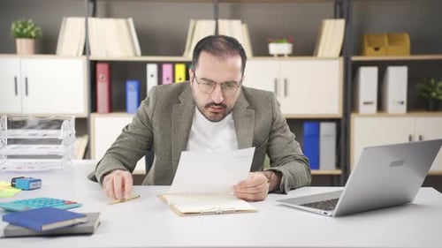 Frustrated Man at Office Desk