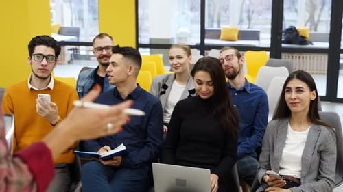 Business Team Listens to Presentation in Office