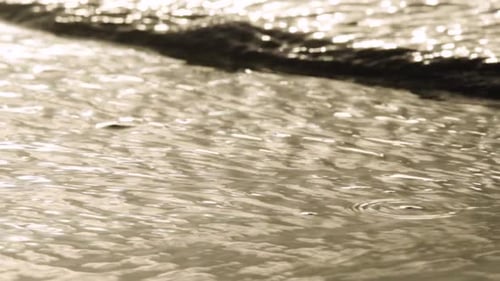 abstract ocean wave ripples on beach shore in slow motion