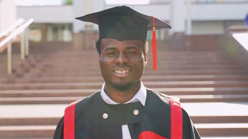 Portrait of Student Graduate Near College