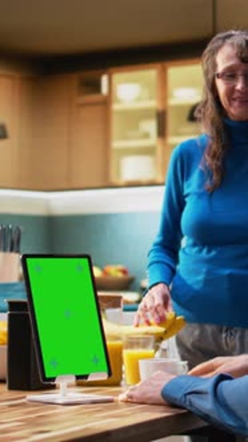 Vertical Video Vertical Green Screen with Mature Husband Sitting at the Table