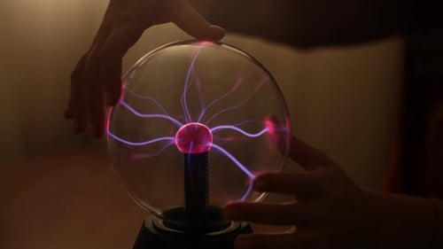 Closeup Hands of Unrecognizable Woman Touching Electric Plasma Ball with Luminous Flames Electric