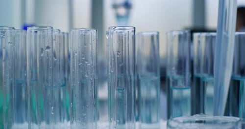 Laboratory Test Tubes Being Filled with Liquid