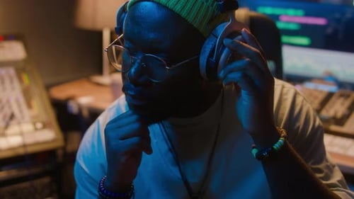 Young Adult Mixing Audio in a Music Studio