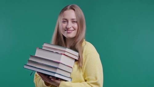 Smiling Student Woman Happy with Stack of Books From Library Blue Background