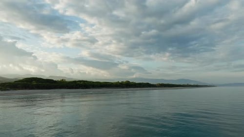 Heavenly Coastline of Tropical Beach Under Cloudy Sky