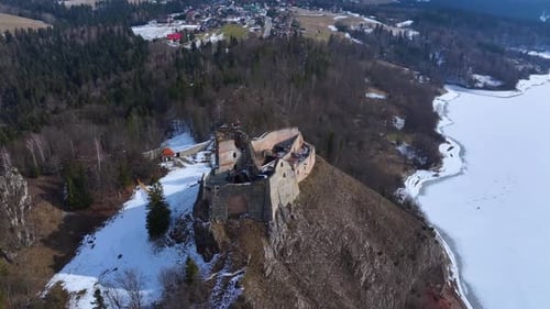 Aerial view of historic castle nestled in serene winter landscape