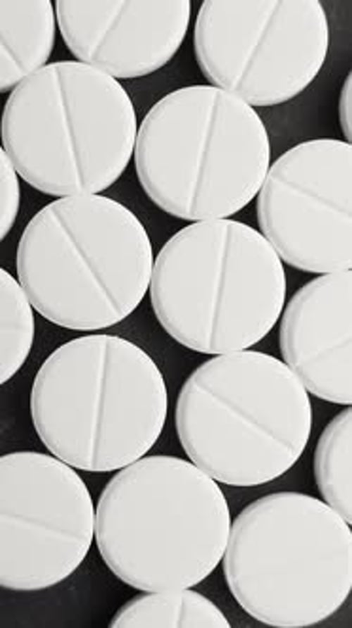 Pile Of Medical Pills Rotating Close Up Top View Vertical Video