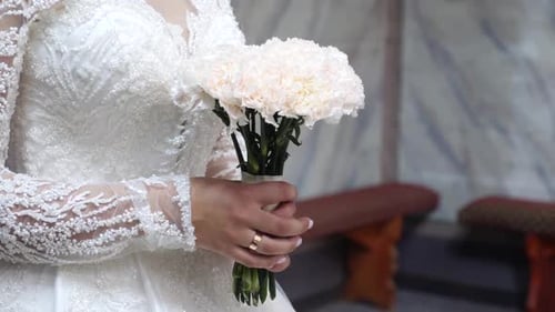 Elegant Bride Holding White Flower Bouquet at Wedding