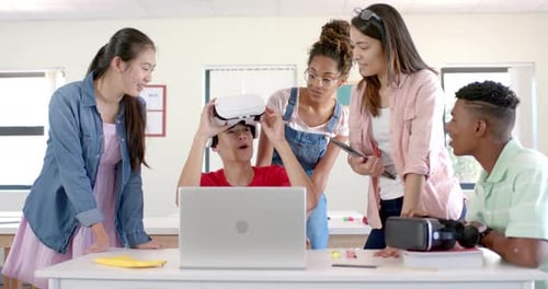Diverse students engage with VR technology in a high school setting