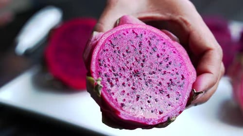 Hands holding dragon fruit Close up of Red and white dragon fruit Red Dragon Fruit Slices and Cultiv