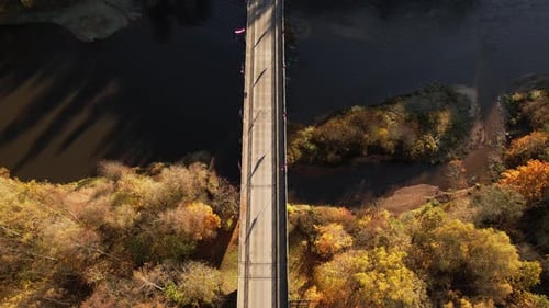 Bridge over a river surrounded by autumn foliage