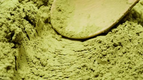 Matcha Green Tea Cooking Process Japanese Powder Green Tea in a Bowl with Bamboo Whisk Macro Close