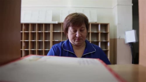 Employee Mail Sorts Letters