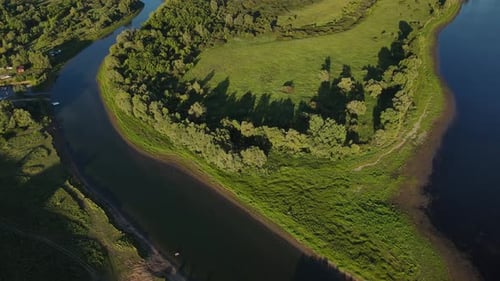 A Scenic River Bend with Lush Greenery in a Countryside Landscape is Captured in an Aerial View