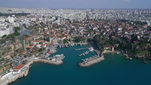 Aerial the Camera Moves in a Circle Over the Old City of Antalya From the Sea