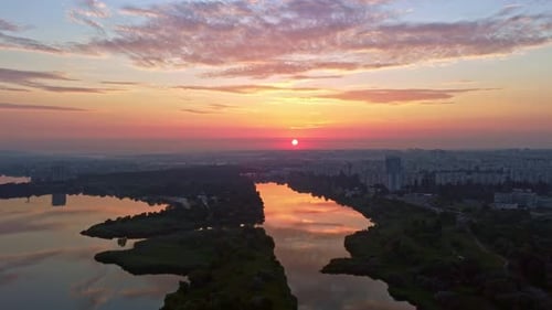 Aerial sunrise sun on river in city park
